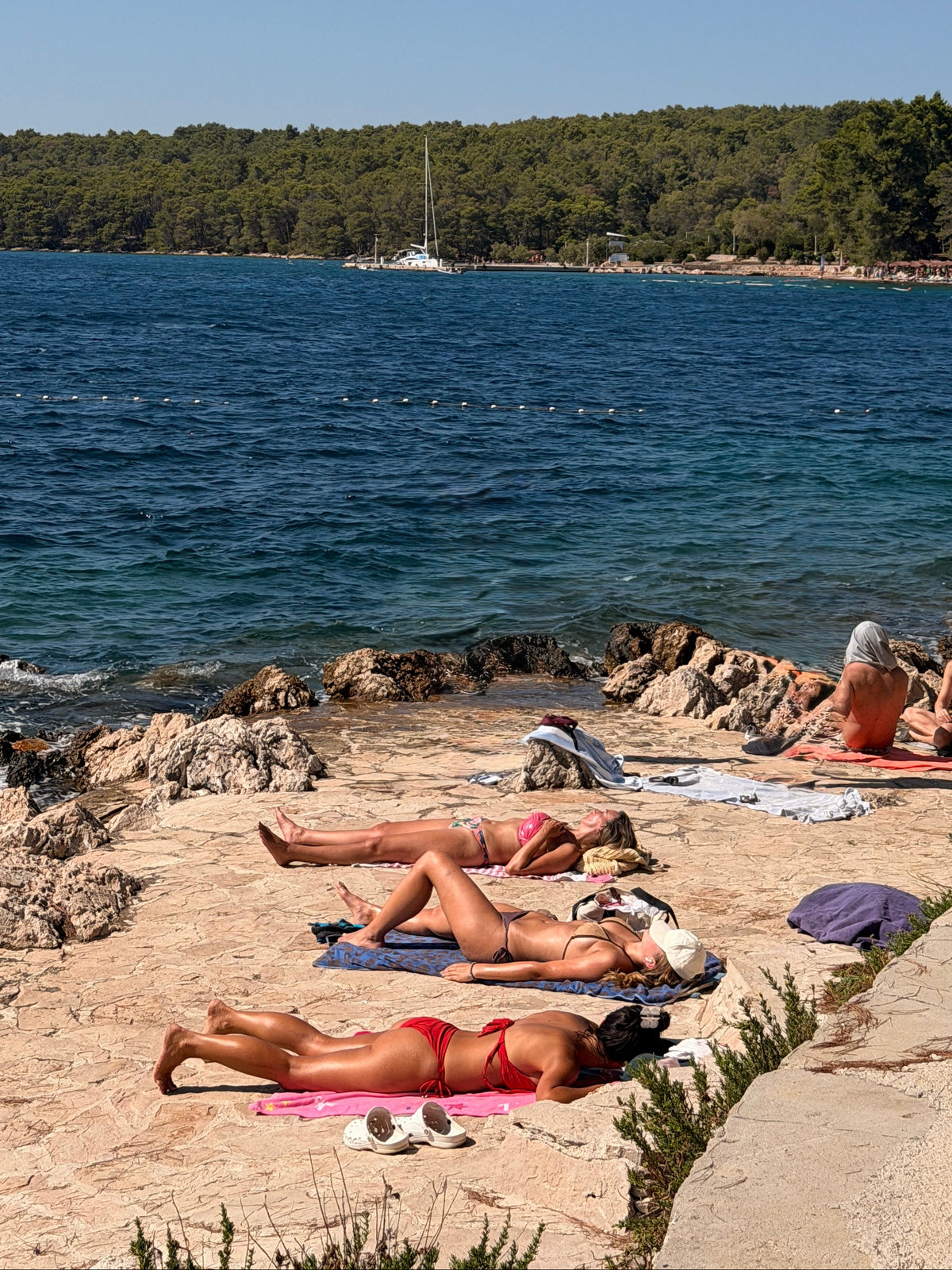 Women enjoying the sunshine and ocean in Croatia on a Sail week Sailing trip from Dubrovnik to Spilt. 